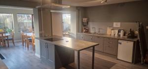 a kitchen with a island in the middle of it at Peedie Sea Accommodation in Orkney