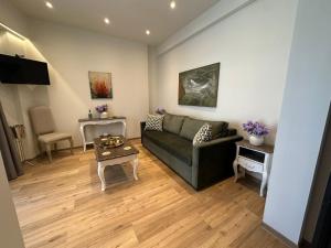 a living room with a couch and a table at Acropolis Divine Apartments in Athens