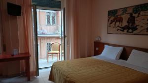 a bedroom with a bed and a window with a chair at Casa Per Ferie Canobi 18 in Rome +35 photos