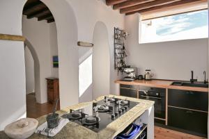 a kitchen with a stove top oven next to a counter at The Artist House in Triandáros