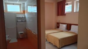 a hotel room with two beds and a bathroom at Casa Per Ferie Canobi 18 in Rome