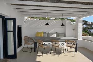 a dining room with a table and chairs on a balcony at The Artist House in Triandáros