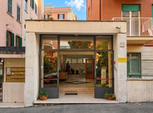 a house with large glass doors in a city at Casa Per Ferie Canobi 18 in Rome