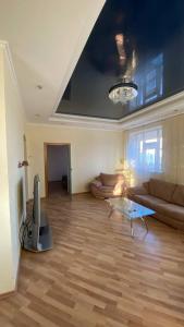 a living room with a couch and a television at Bright House in Bila Tserkva