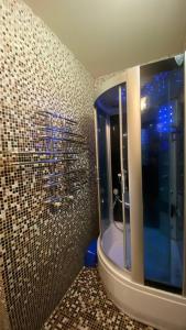 a bathroom with a shower and a bath tub at Bright House in Bila Tserkva