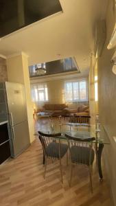 a kitchen and living room with a table and chairs at Bright House in Bila Tserkva