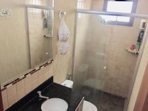 a bathroom with a shower and a sink and a toilet at Casa mobiliada BR 153 in Aparecida de Goiânia