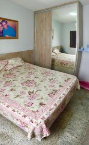 a bedroom with a bed and a mirror in it at Casa mobiliada BR 153 in Aparecida de Goiânia