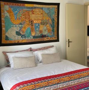 a bedroom with a bed with a picture of an elephant at Lulus Kastri in Keratokampos
