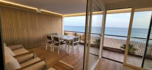 a room with a balcony with a view of the ocean at Levante Frontline Luxury Duplex 5 Bedrooms in Benidorm