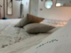 a bed with two pillows on top of it at Suite La Corte in Florence