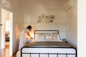 a woman standing next to a bed in a room at Croftby Hills - Scenic Rim in Croftby +56 photos