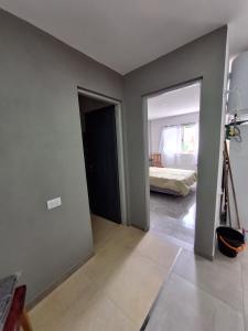 a room with a room with a bed and a camera at departamentos 4 personas,N3 Aire acondicionado Wifi TvCable Parrilla in Santa Teresita