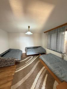 a bedroom with two beds and a window at Vila AT in Sarajevo