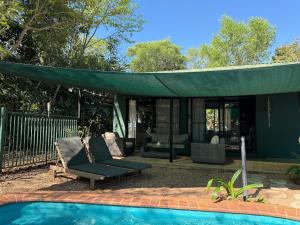 a house with a green canopy over a pool at Jungle Hut - RARE absolute beachfront! in Dundee Beach