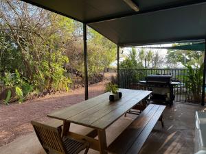 a picnic table and a grill on a patio at Jungle Hut - RARE absolute beachfront! in Dundee Beach