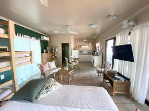 a bedroom with a bed and a living room at Jungle Hut - RARE absolute beachfront! in Dundee Beach