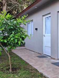 a door to a house with a patio at departamentos 4 personas,N3 Aire acondicionado Wifi TvCable Parrilla in Santa Teresita