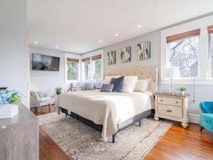 a bedroom with a bed and a couch and windows at Historic Home with King Bed in High Point