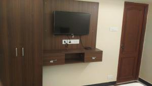 a television on a wall in a room at AR Residency Tnagar Chennai in Chennai