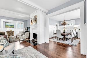 a dining room and living room with a fireplace at Historic Home with King Bed in High Point