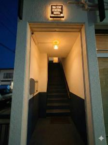 a stairway leading to a building with a sign on it at -Ina Stay Central Hotel-8名宿泊可 伊那市駅徒歩5分 駐車場無料 a sleep8-a 5minute walk from the station-Free parking in Ina