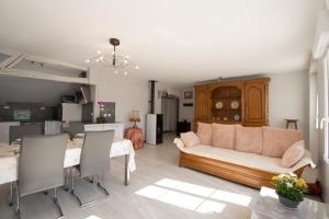 a living room with a couch and a table at La maison bleue in Lusigny-sur-Barse