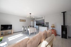 a living room with a couch and a table at La maison bleue in Lusigny-sur-Barse