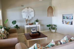 a living room with a couch and a table at Planet Scuba Bed and Breakfast in Ponta do Ouro