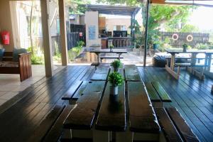 a patio with a wooden table with plants on it at Planet Scuba Bed and Breakfast in Ponta do Ouro