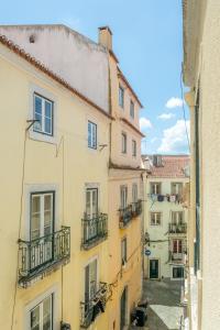 a group of buildings with balconies on a street at Suites - Elevador da Bica in Lisbon