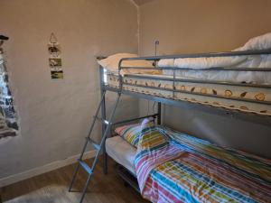 a bedroom with a bunk bed with a pillow on the bottom bunk at Gîte Marie, Beynat, Corrèze in Beynat