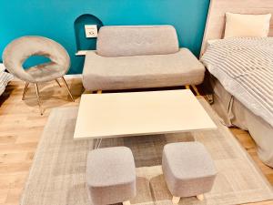 a bedroom with a bed and a chair and a table at 町の中心地 星もきれいな貸切宿 "うみいろキャビン " "umiiro cabin" in Ainan +18 photos