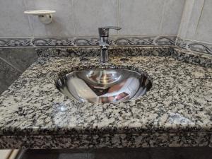 a bathroom sink with a granite counter top at Alojamientos Estrellas Azules in Colón +86 photos