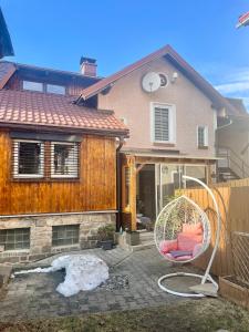 a house with a chair in front of it at Apartment Krkonošská in Tanvald