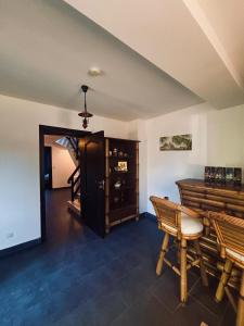 a living room with a wooden table and a staircase at Vila Antanta Podu' Cu Lanturi in Bacău