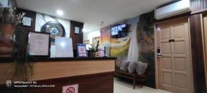 a lobby with a reception desk and a door at Tanjong Boutique Hotel in TanjongMalim