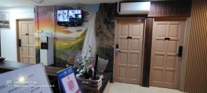 a room with two doors and a tv on the wall at Tanjong Boutique Hotel in TanjongMalim
