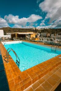 a swimming pool on the top of a building at Aparthotel MONTERREY in Puerto Rico de Gran Canaria