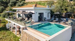 an aerial view of a house with a swimming pool at Villa Mimosa with private swimming pool in Ágios Márkos