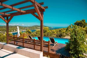 a villa with a view of the pool and the ocean at Marepromo Žirje in Žirje