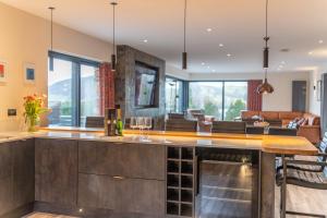 a kitchen with a bar with wine glasses at Parklands in Penrith