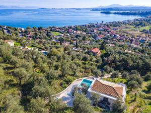 an aerial view of a villa with a view of the water at Villa Mimosa with private swimming pool in Ágios Márkos