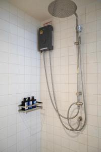 a shower with a shower head in a bathroom at Arunne in Bangkok Yai +32 photos