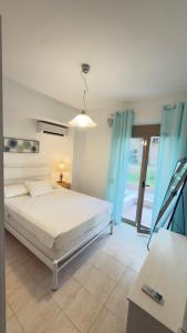 a bedroom with a bed with blue curtains at Oikos Apartment in Hanioti