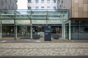 a glass building with a sign in front of it at Fitzroy Court near Luton Airport in Luton