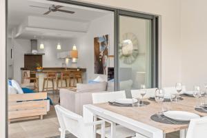 a dining room and living room with a table and chairs at Ama Villas - Luxury Private Villas in Mont-Choisy Beach in Mont Choisy +30 photos