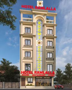 a tall building with a hotel ramale sign on it at Hotel Ramlalla in Khātu