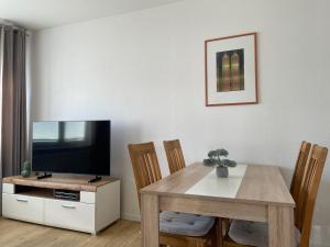 a living room with a table and a television at Ferienhaus Wehretal - auf separatem Grundstück in Langenhain