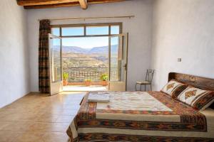 a bedroom with a bed and a large window at Birhanu Guest House and Tours in Lalibela